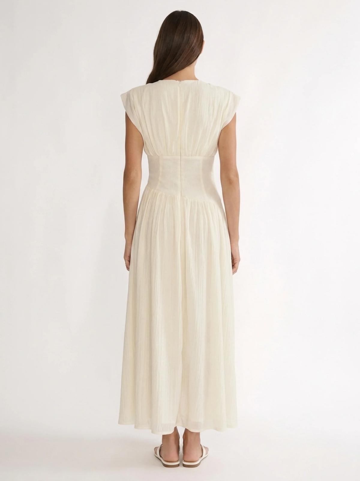 Hazel V-neck ruched maxi dress with asymmetric waist in white — back view