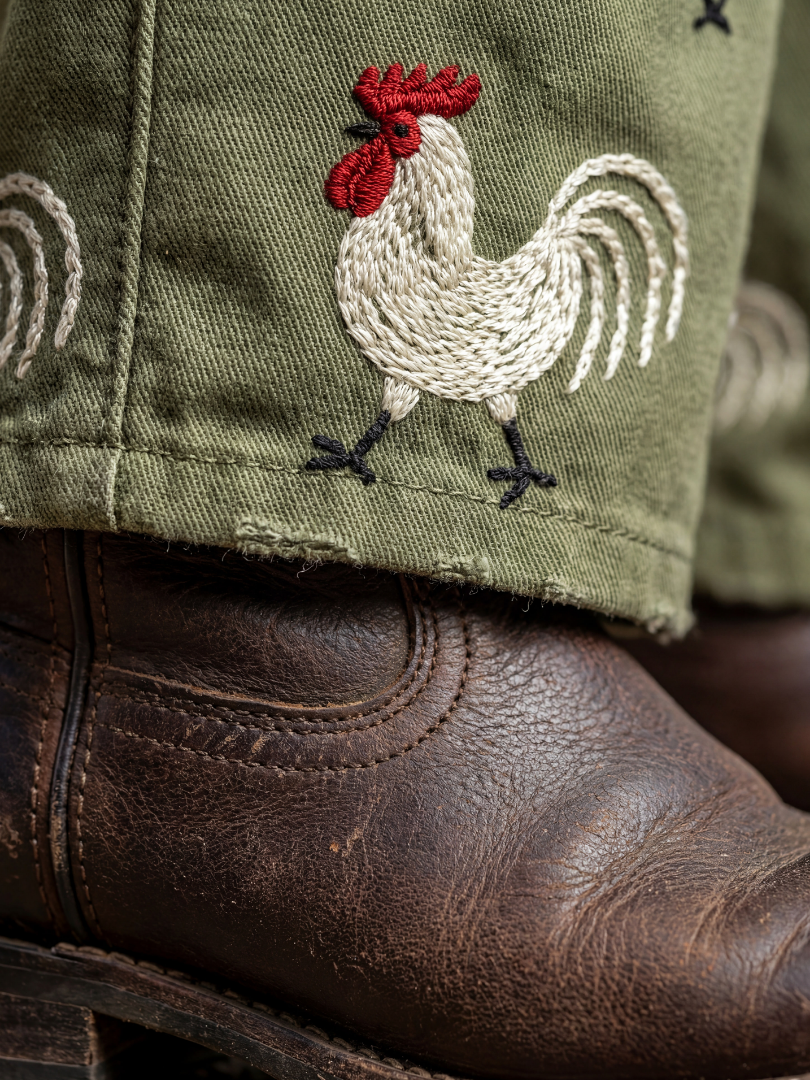 Cassia rooster print bib-front dungarees — detail view