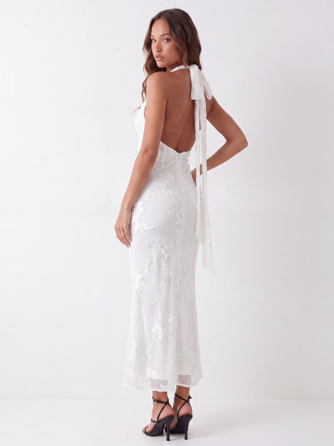 Capri backless halter maxi dress with floral embellishment in white — back view