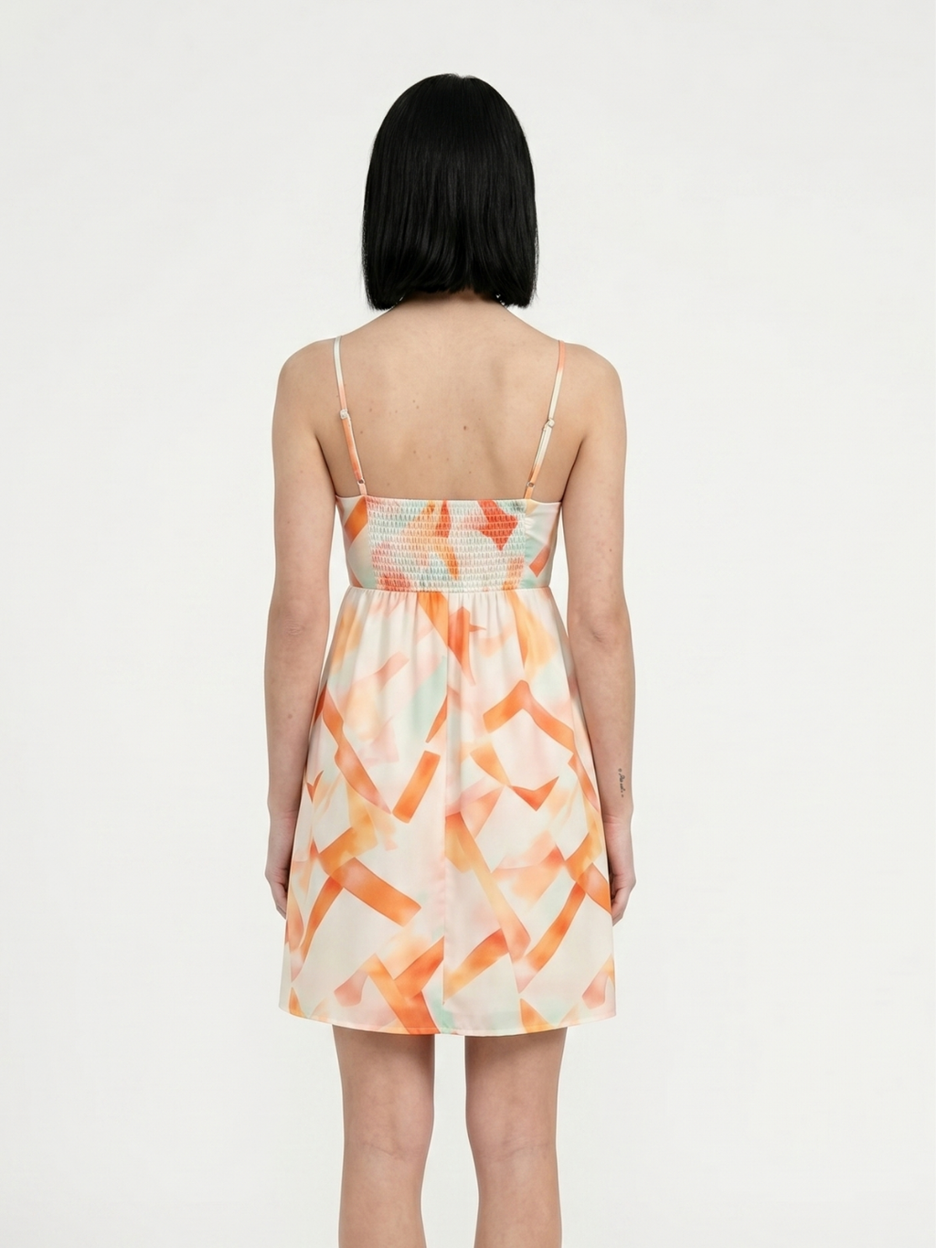 Luna square-neck mini dress in orange abstract print — back view