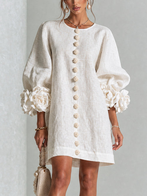 Ivory long sleeve mini dress with rosette cuffs and floral buttons