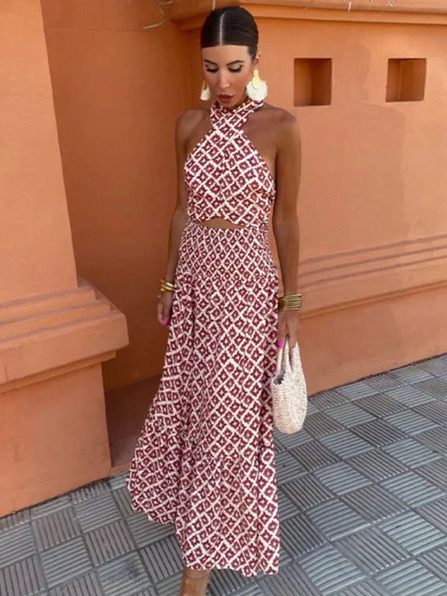 Woman wearing a red and cream geometric print halter crop top and matching maxi skirt set