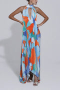 Pleated halter maxi dress in an orange and blue abstract print with keyhole neckline and open back