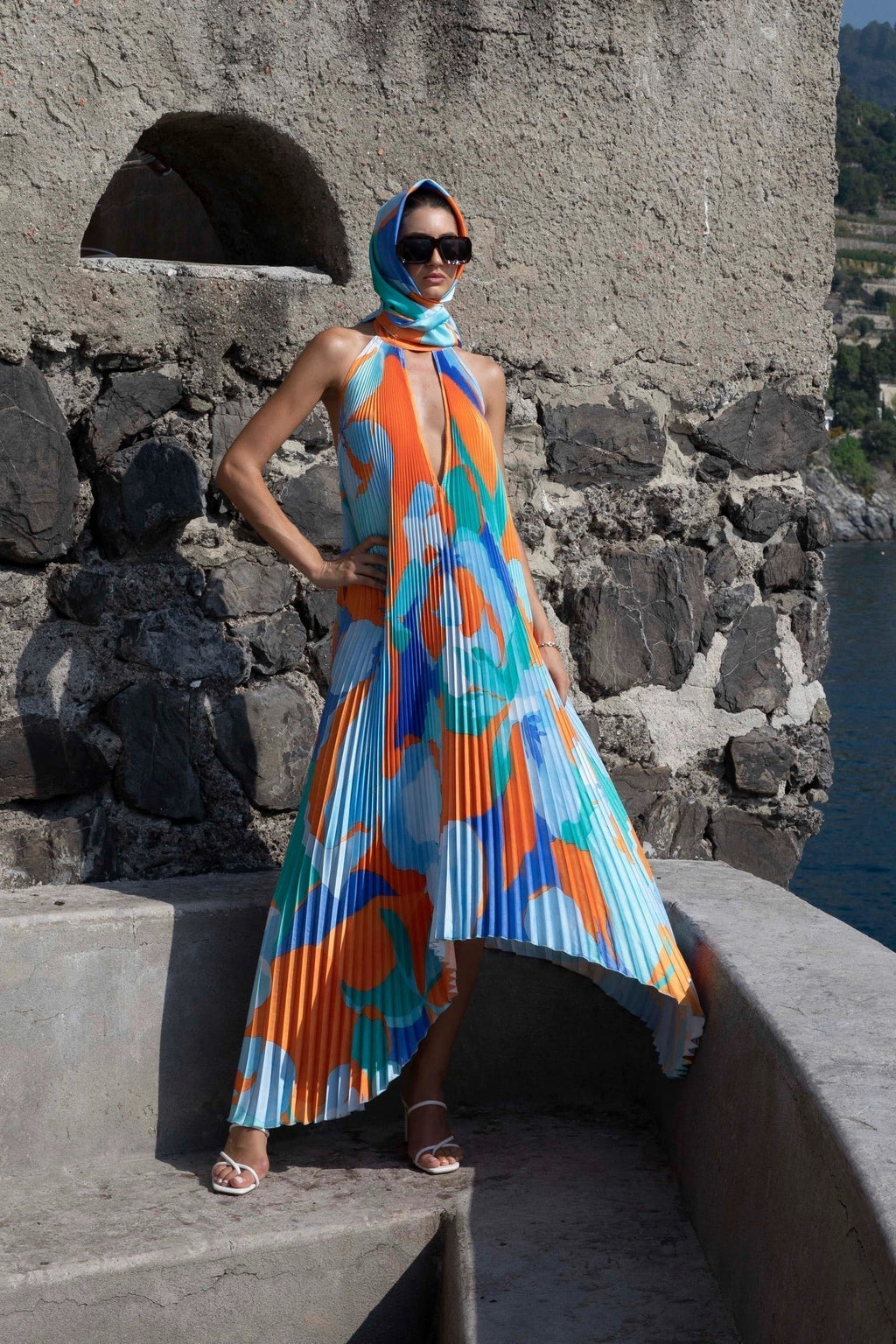 Pleated halter maxi dress in an orange and blue abstract print with keyhole neckline and open back - view 4