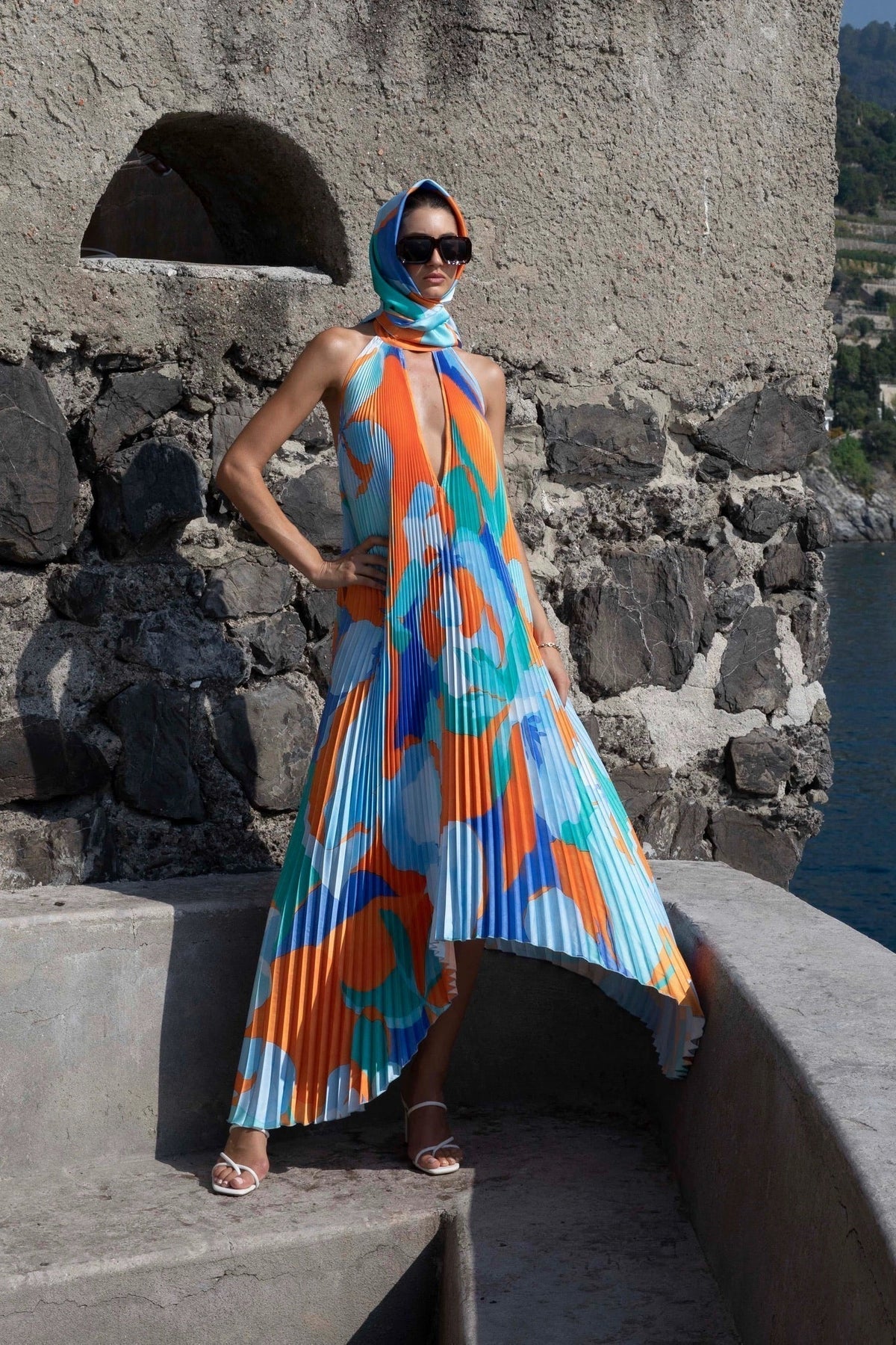 Pleated halter maxi dress in an orange and blue abstract print with keyhole neckline and open back - view 4
