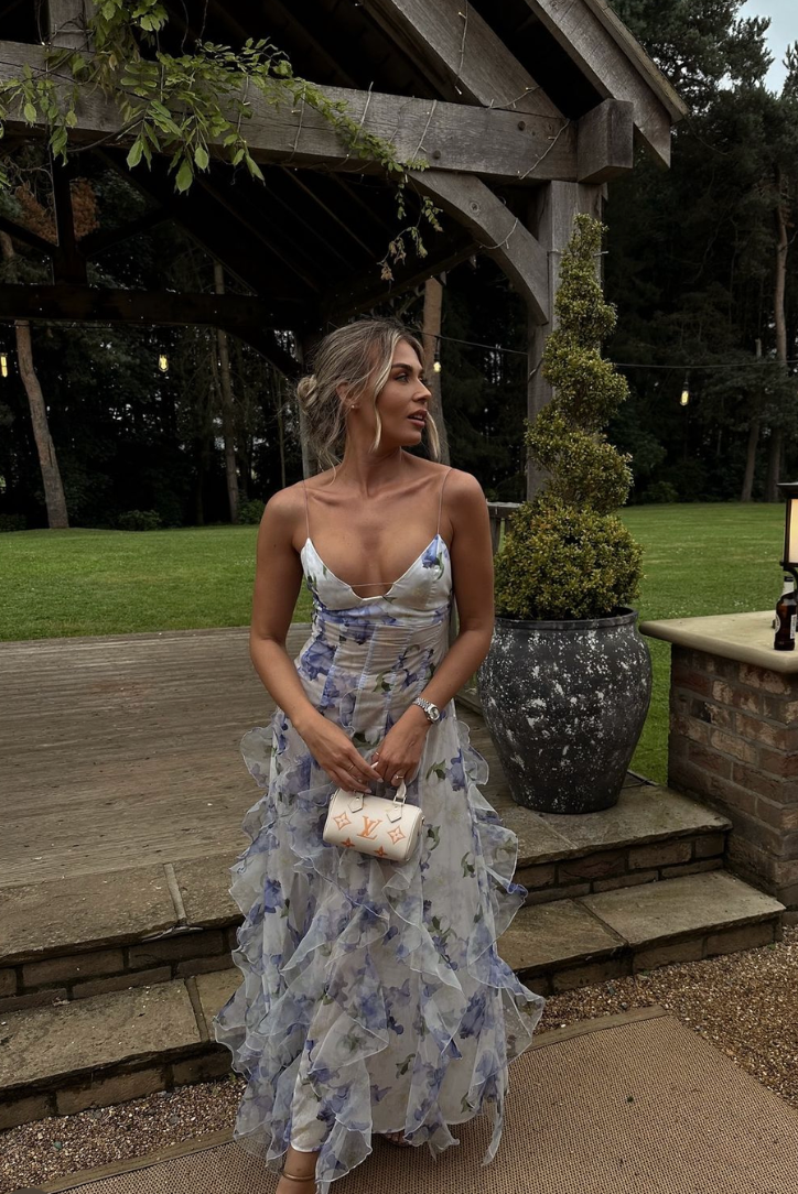 Woman wearing a blue and ivory floral maxi dress with corset bodice and ruffled skirt - view 6