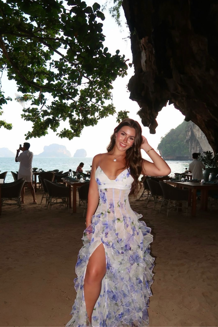 Woman wearing a blue and ivory floral maxi dress with corset bodice and ruffled skirt - view 7