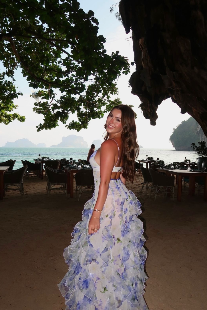 Woman wearing a blue and ivory floral maxi dress with corset bodice and ruffled skirt - view 8
