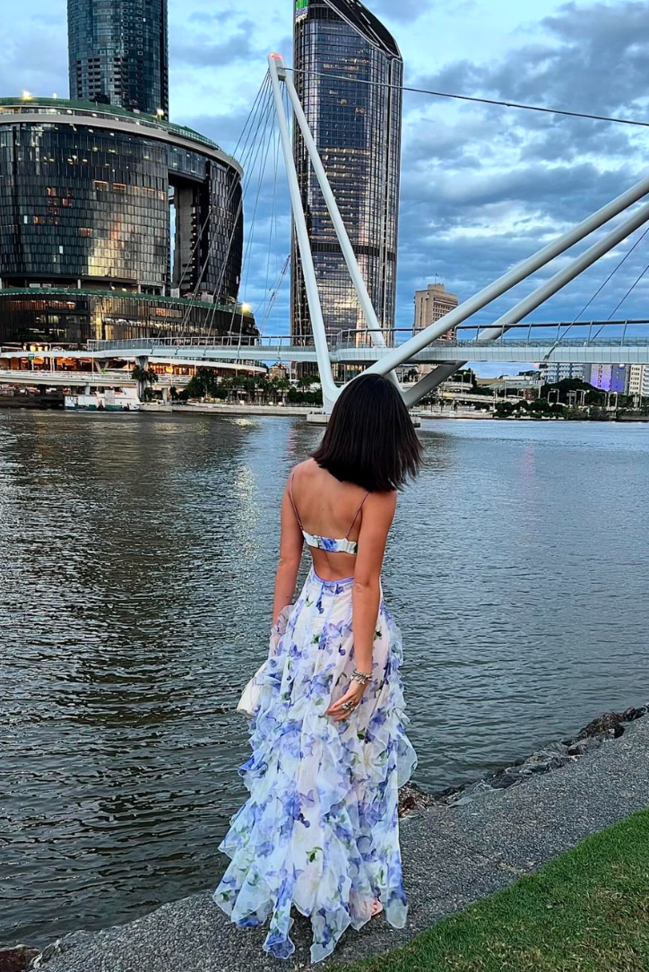 Woman wearing a blue and ivory floral maxi dress with corset bodice and ruffled skirt - view 9