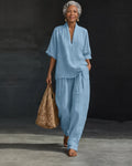 Woman wearing a V-neck two piece set with wide leg pants