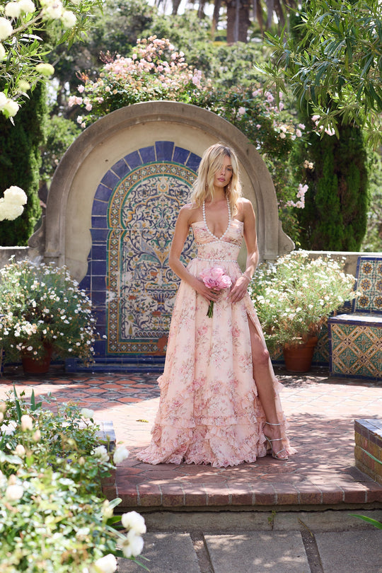 Woman wearing a floral corset maxi dress with a beaded halter neckline and a ruffle hem - view 7