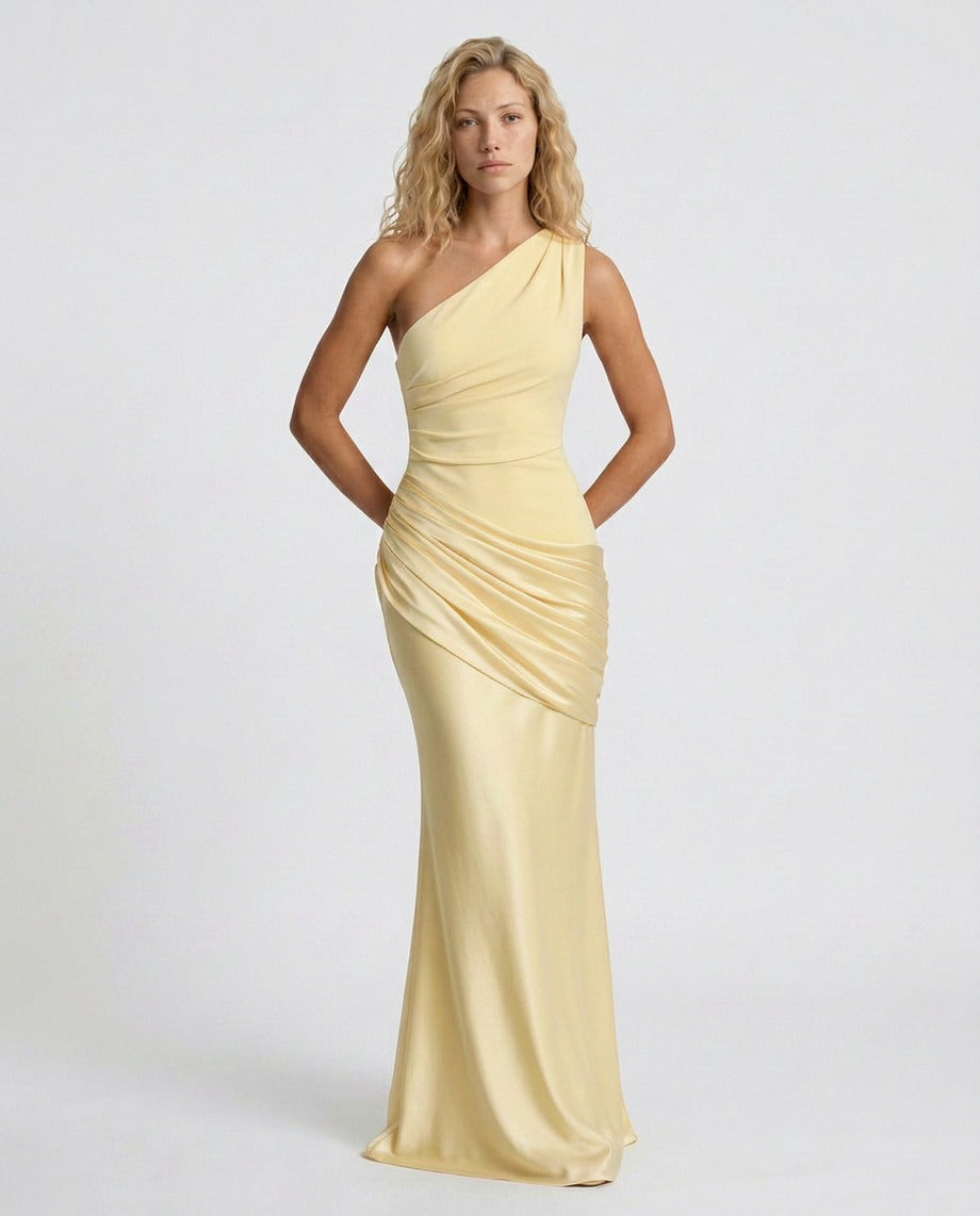 Woman wearing a one shoulder satin formal maxi dress with ruched bodice and draped hip panel