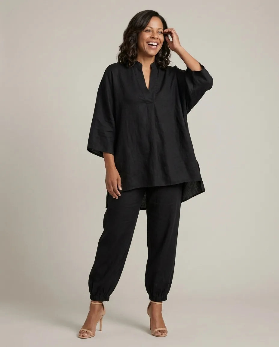 Woman in a black batwing V-neck tunic and cuffed pants matching set