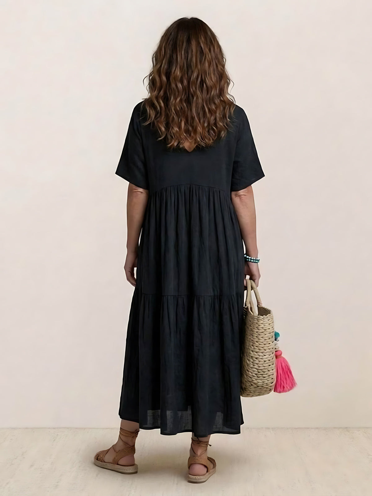Woman wearing a V-neck tiered maxi dress with short sleeves - view 36