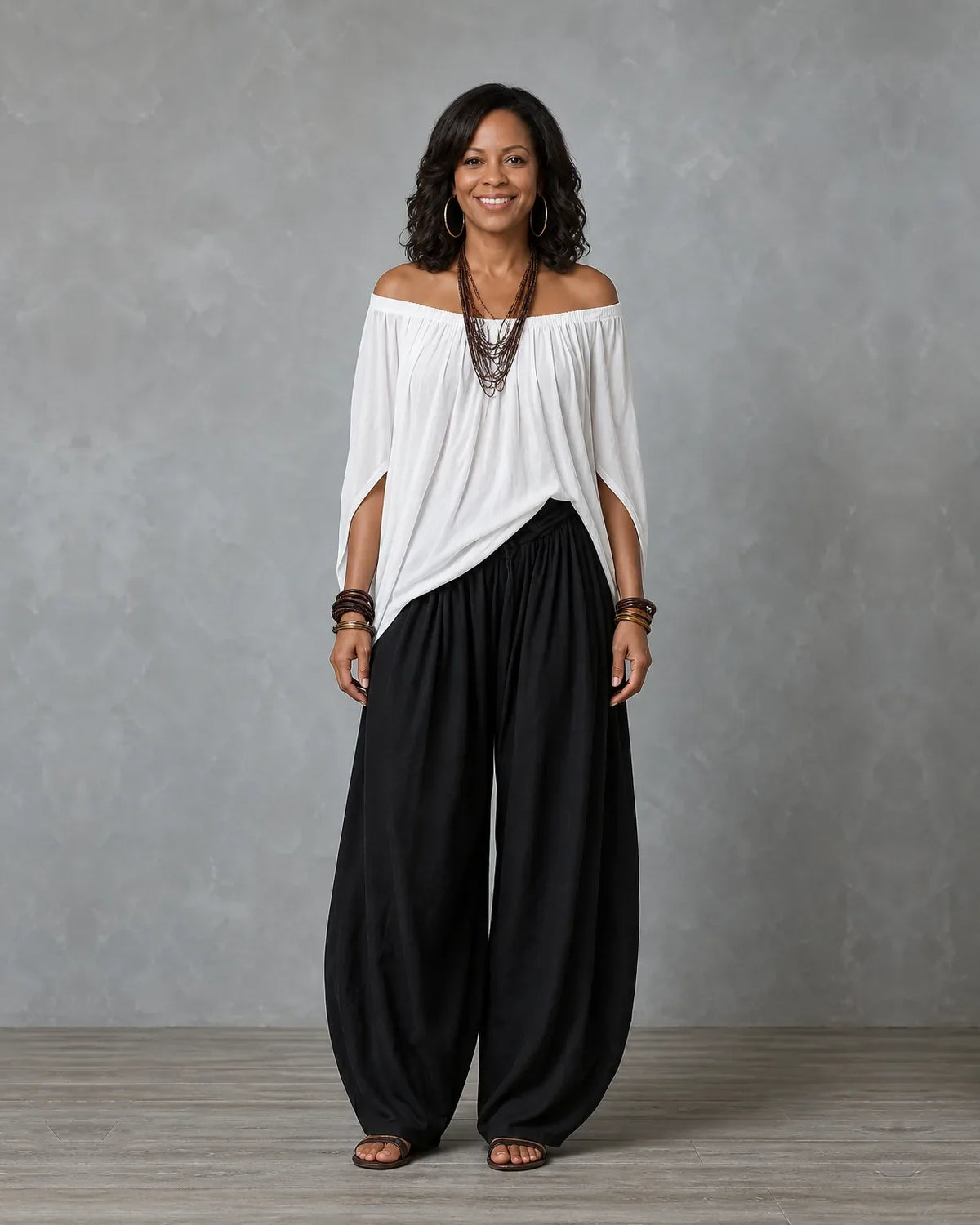 Woman in an off shoulder two piece set with split sleeves and balloon wide leg pants