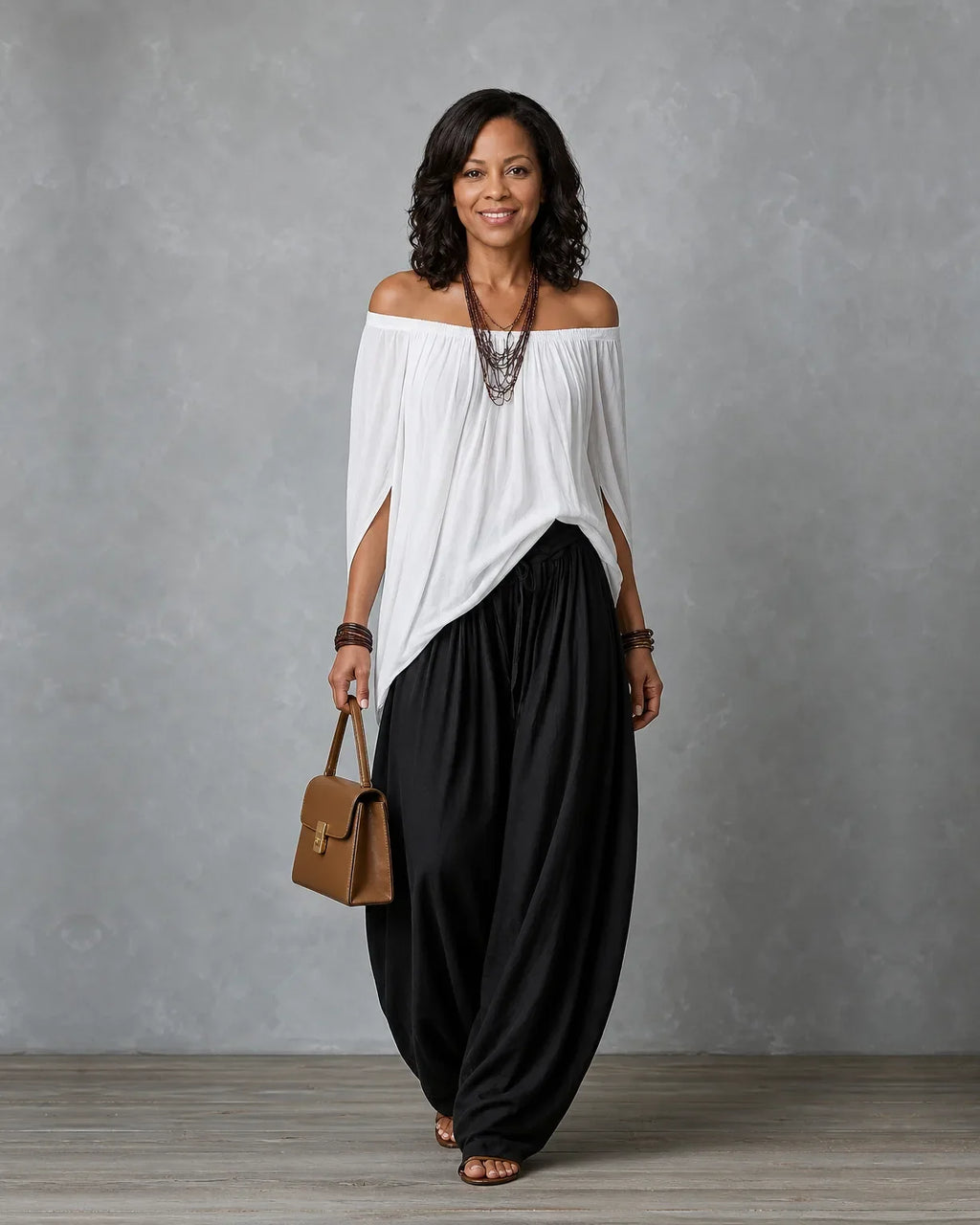 Woman in an off shoulder two piece set with split sleeves and balloon wide leg pants - view 2
