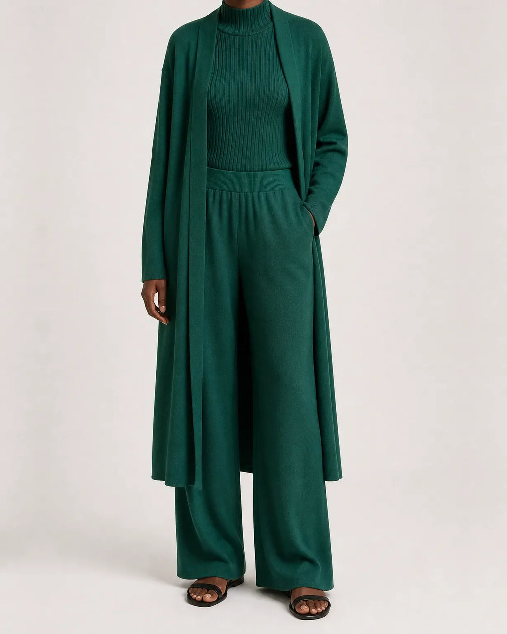 Woman wearing a three piece knit set with longline cardigan, ribbed mock-neck top and wide leg pants - view 5