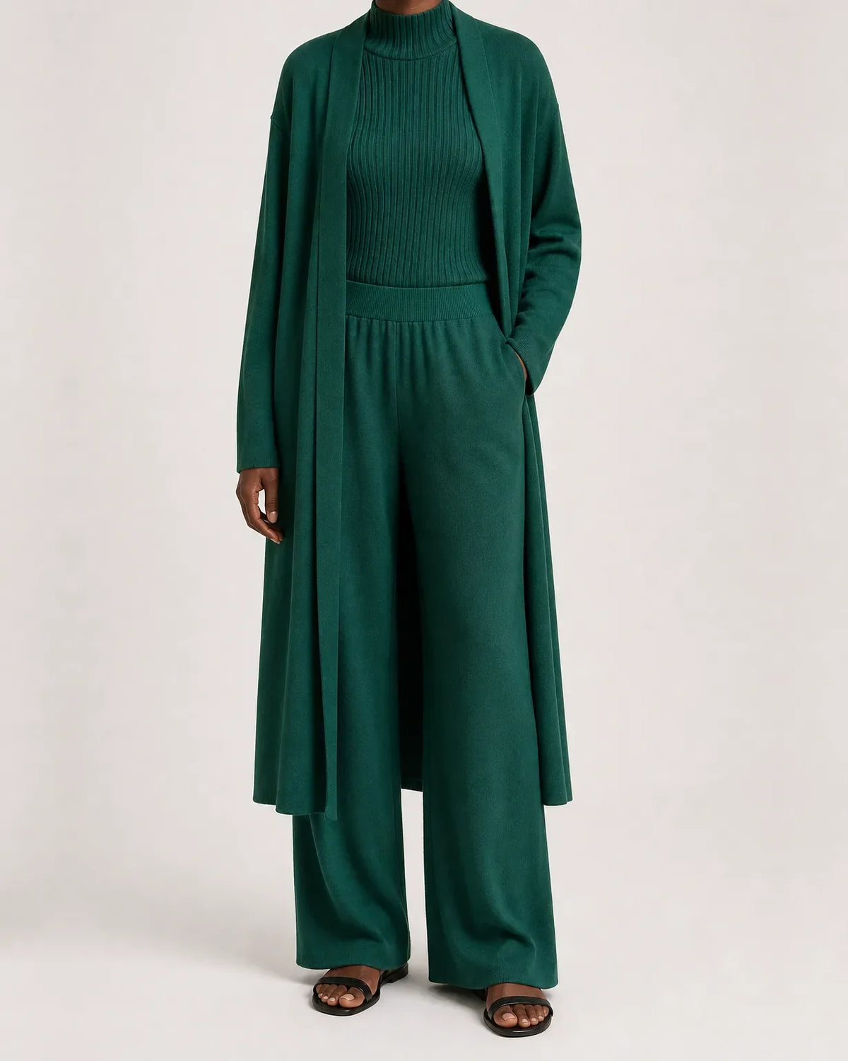 Woman wearing a three piece knit set with longline cardigan, ribbed mock-neck top and wide leg pants - view 5