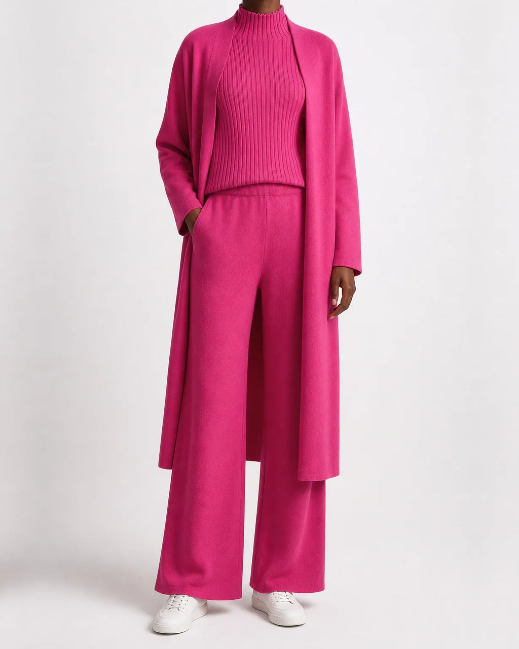 Woman wearing a three piece knit set with longline cardigan, ribbed mock-neck top and wide leg pants - view 6