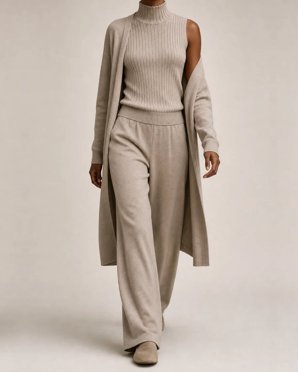 Woman wearing a three piece knit set with longline cardigan, ribbed mock-neck top and wide leg pants - view 8