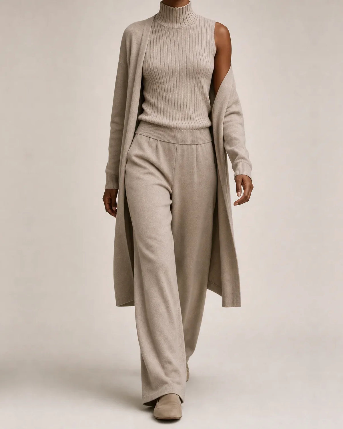 Woman wearing a three piece knit set with longline cardigan, ribbed mock-neck top and wide leg pants - view 8