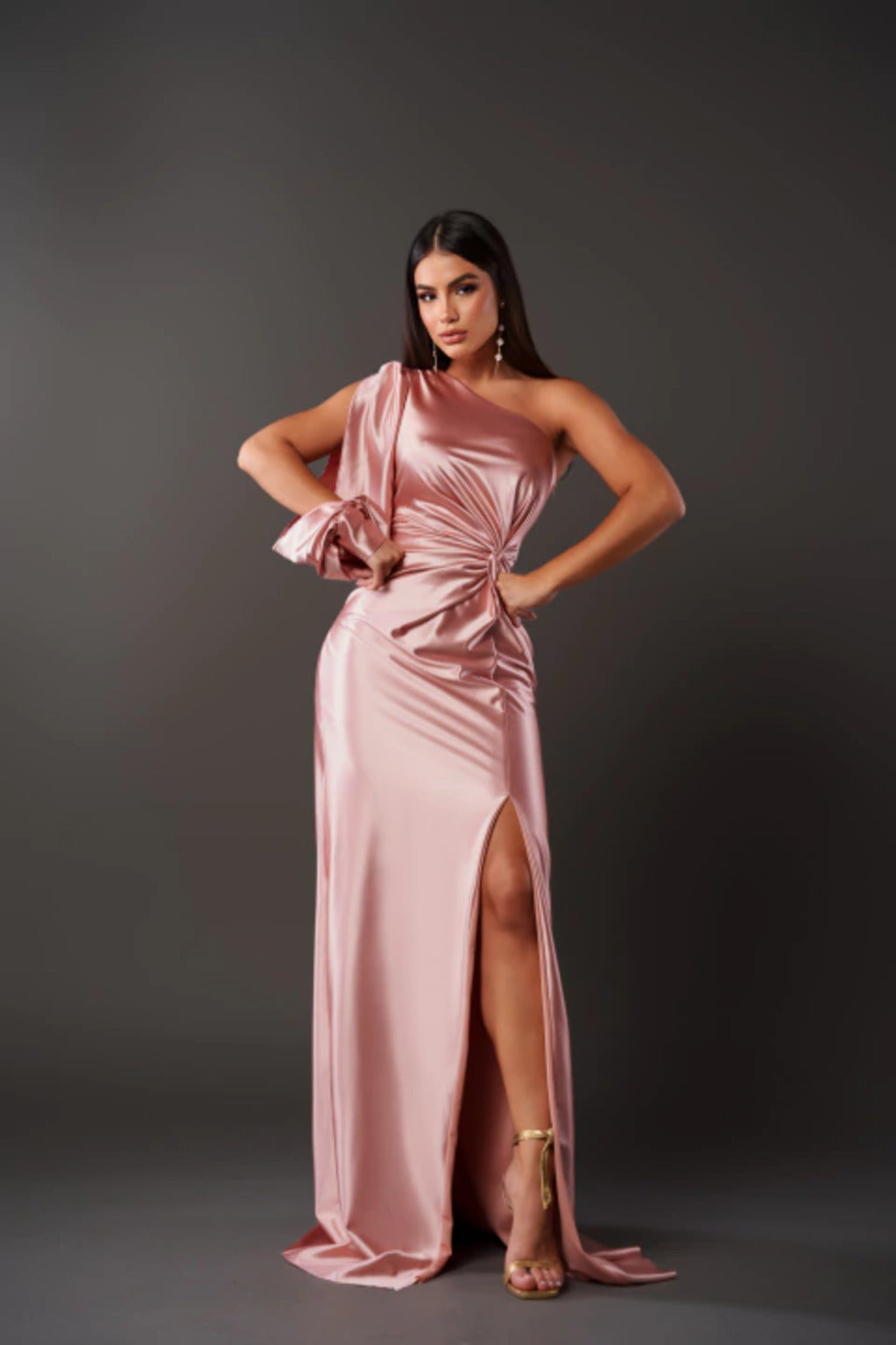 Woman wearing a one shoulder satin formal maxi dress with split sleeve and front slit - view 13
