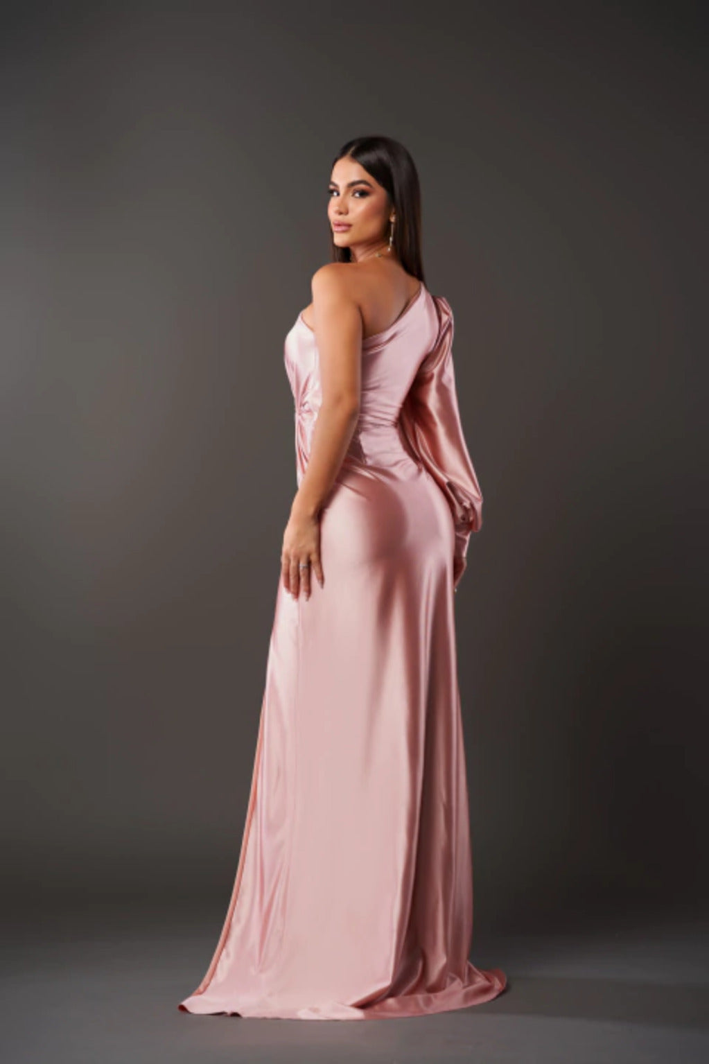 Woman wearing a one shoulder satin formal maxi dress with split sleeve and front slit - view 14