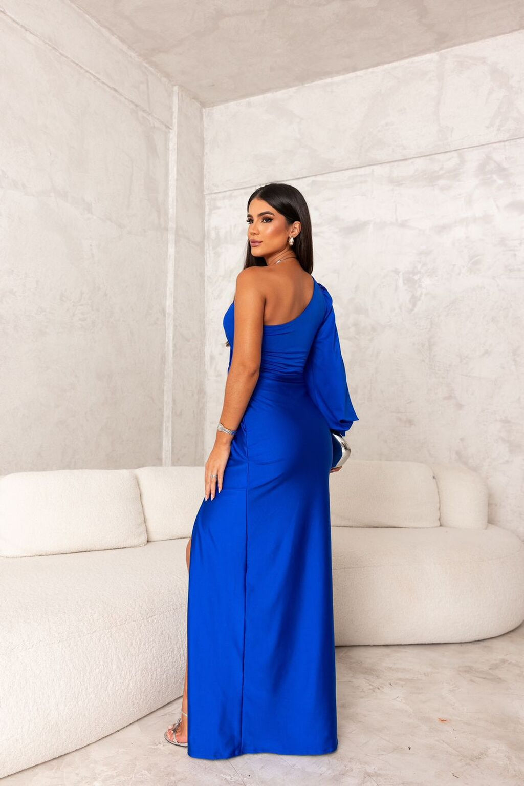 Woman wearing a one shoulder satin formal maxi dress with split sleeve and front slit - view 9