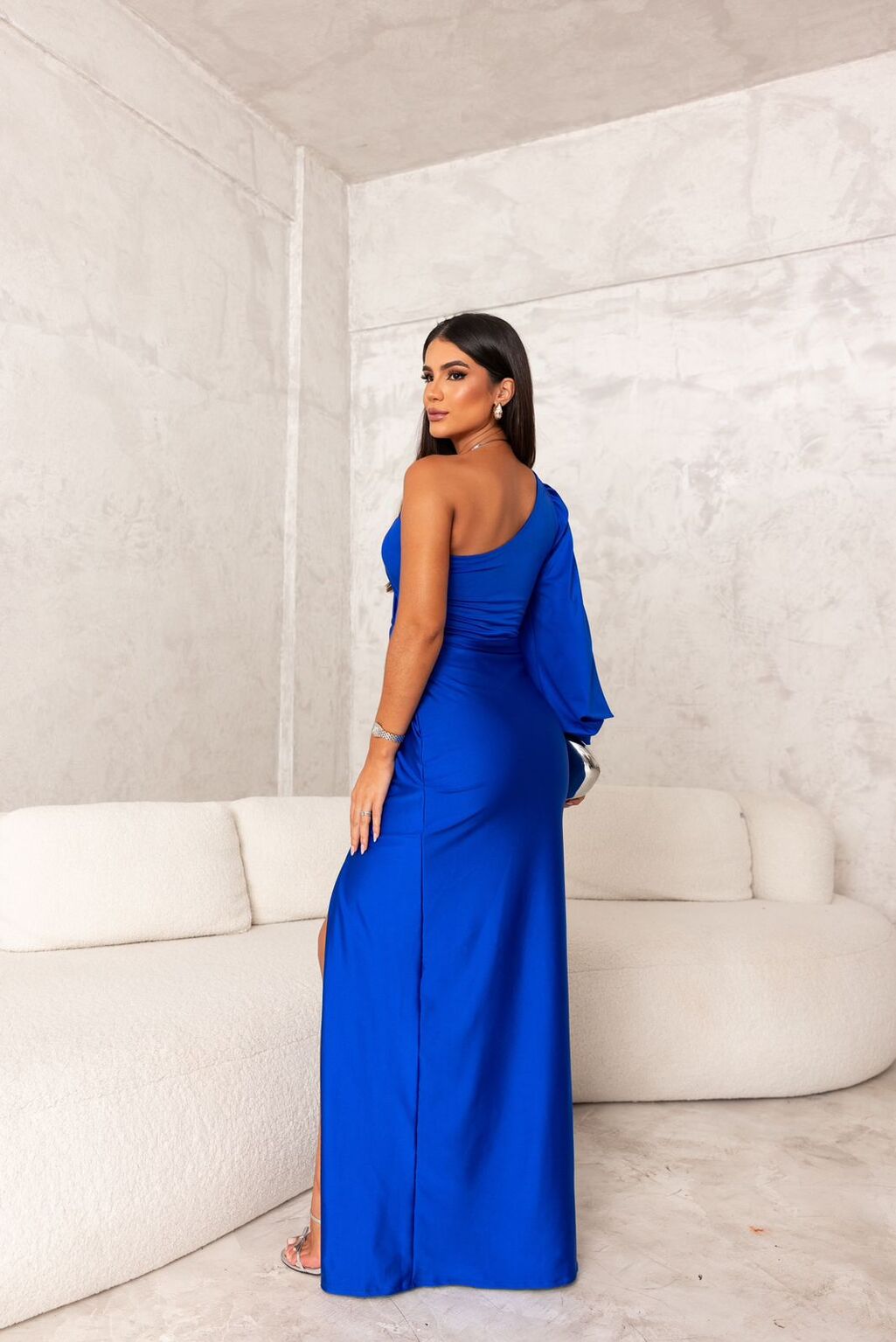 Woman wearing a one shoulder satin formal maxi dress with split sleeve and front slit - view 9