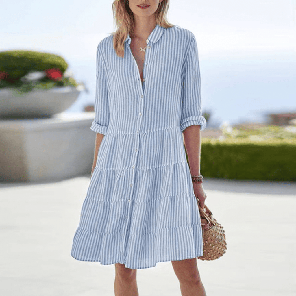 Woman wearing a striped tiered A-line shirt dress with collar and rolled sleeves - view 5