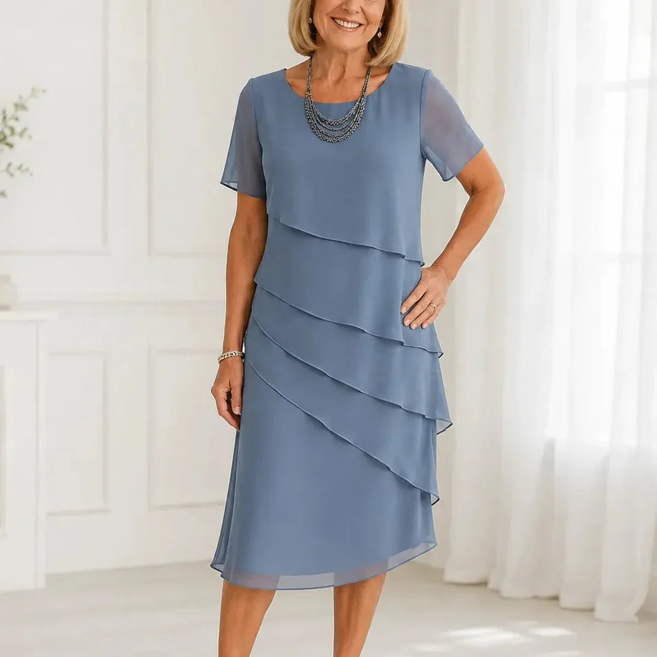 Woman wearing a tiered midi dress with sheer short sleeves for a formal event - view 11