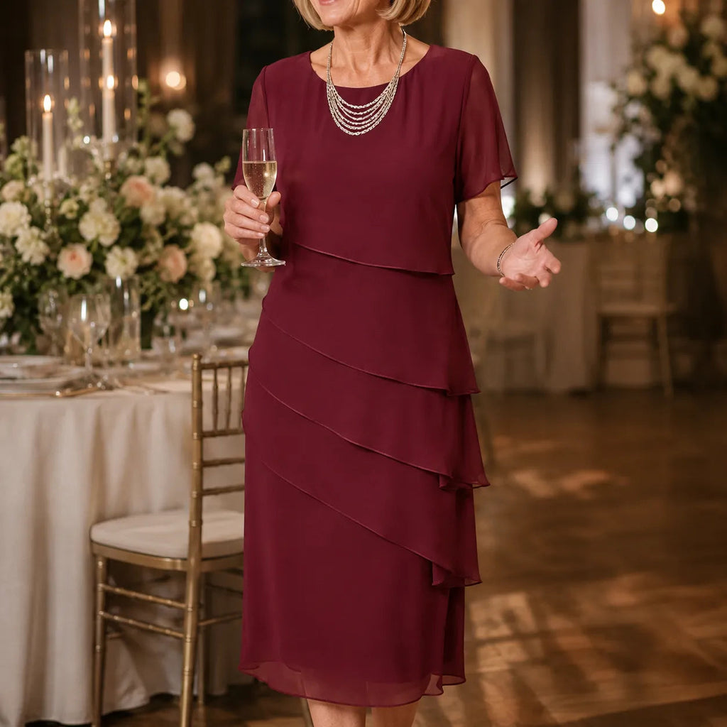 Woman wearing a tiered midi dress with sheer short sleeves for a formal event - view 2