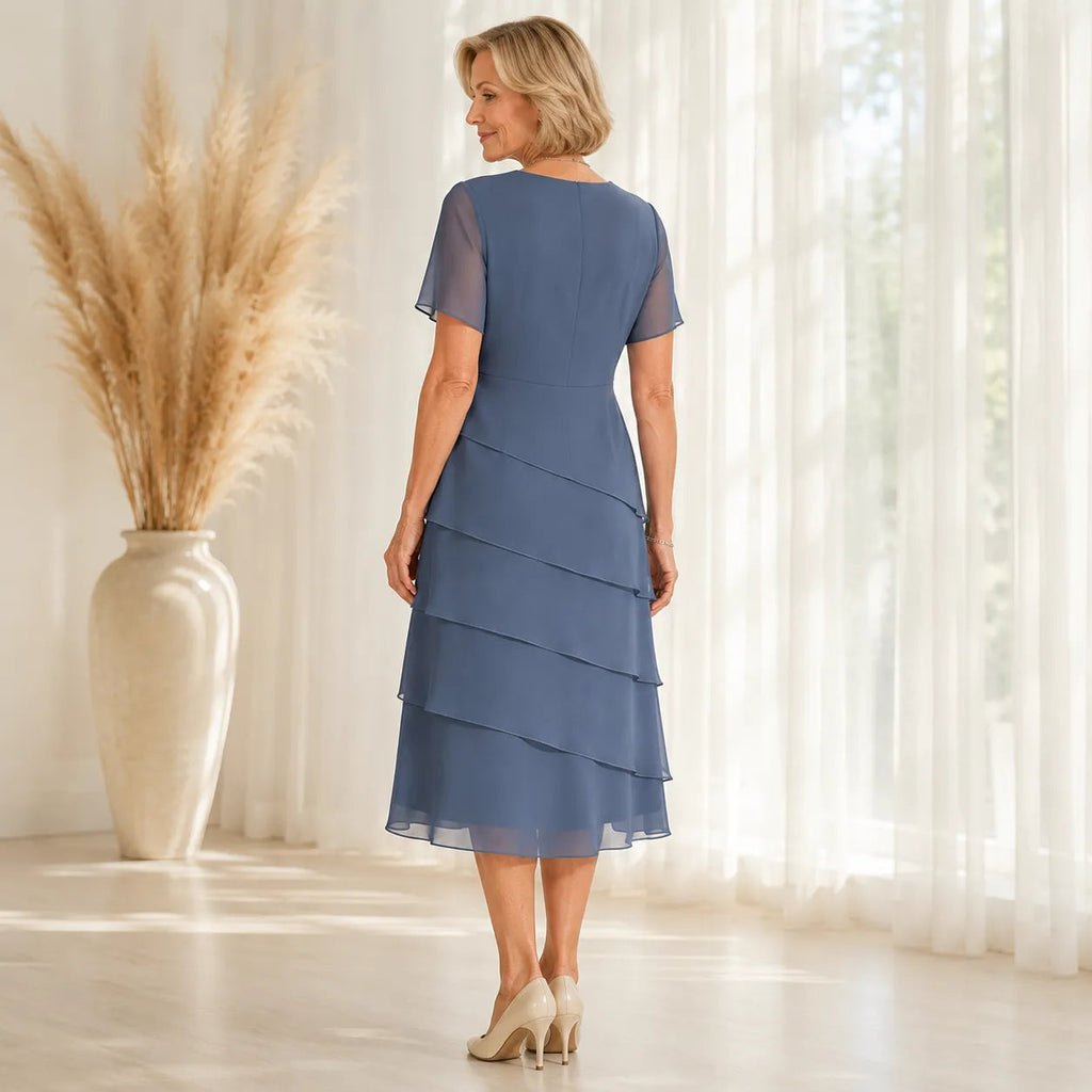 Woman wearing a tiered midi dress with sheer short sleeves for a formal event - view 3