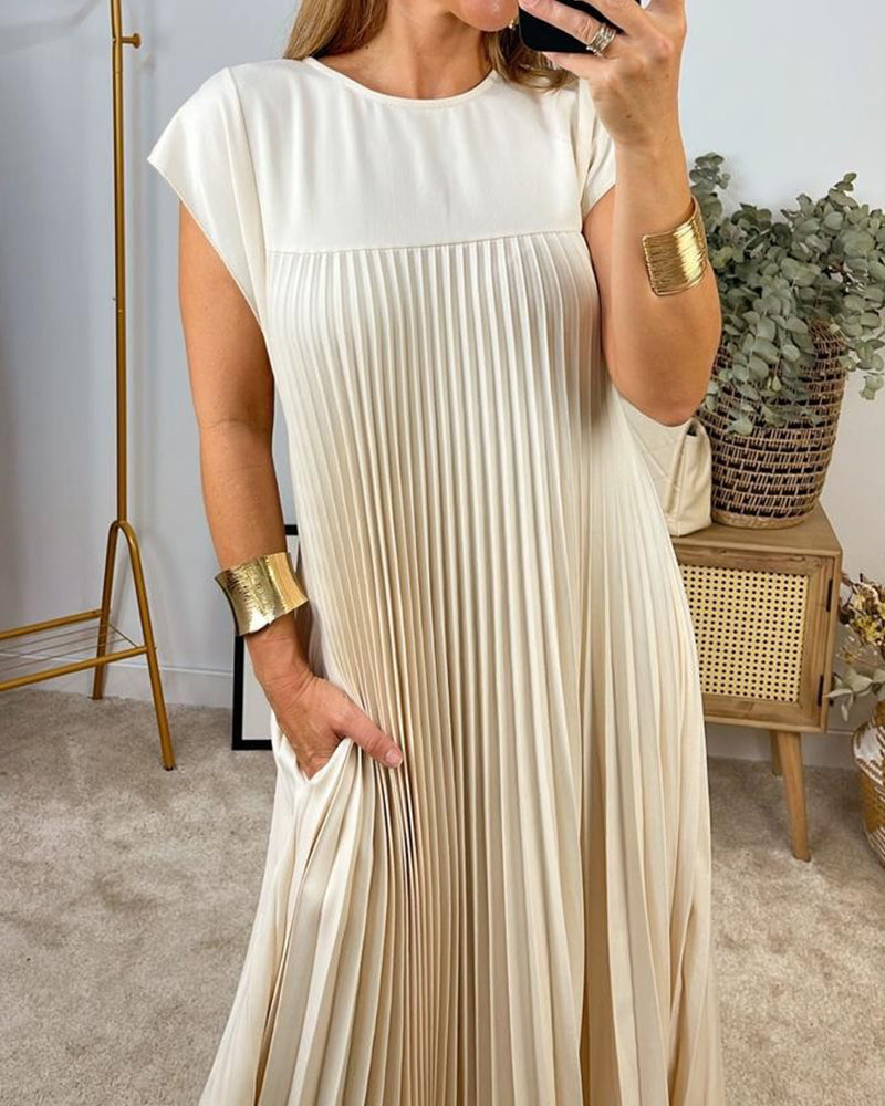 Woman wearing a pleated cocktail maxi dress with round neck and cap sleeves
