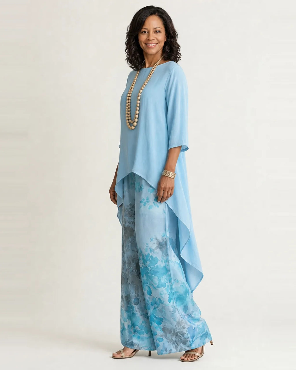 Woman wearing a two piece set with an asymmetric tunic and wide-leg floral pants - view 2