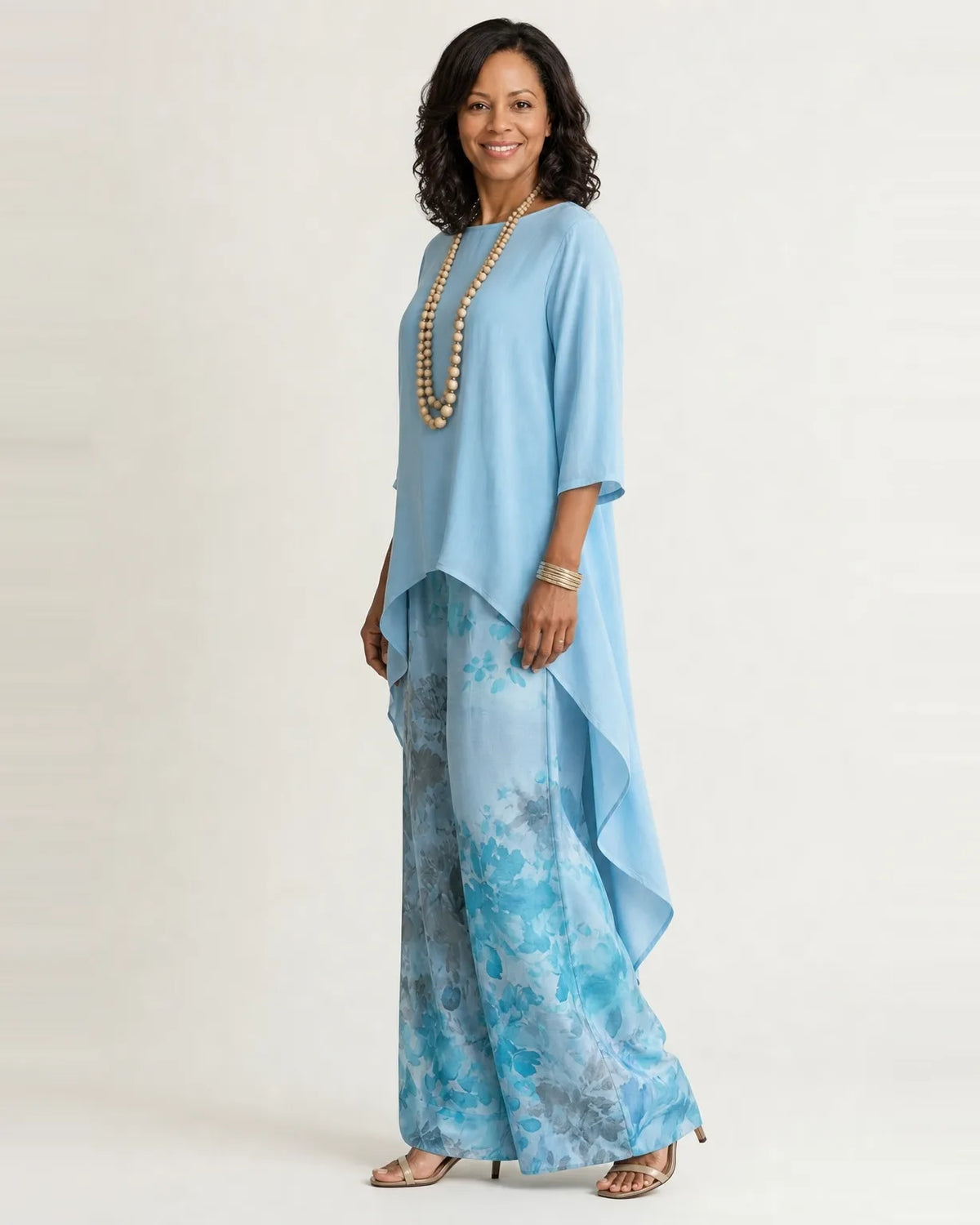 Woman wearing a two piece set with an asymmetric tunic and wide-leg floral pants - view 2