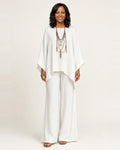 Woman wearing a boho two piece set with an oversized asymmetric top and wide-leg pants