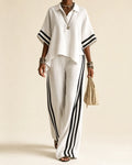 Woman wearing a side stripe two piece set with polo collar top and wide leg pants